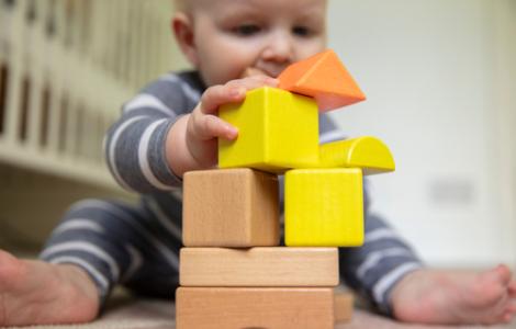 infant with building blocks
